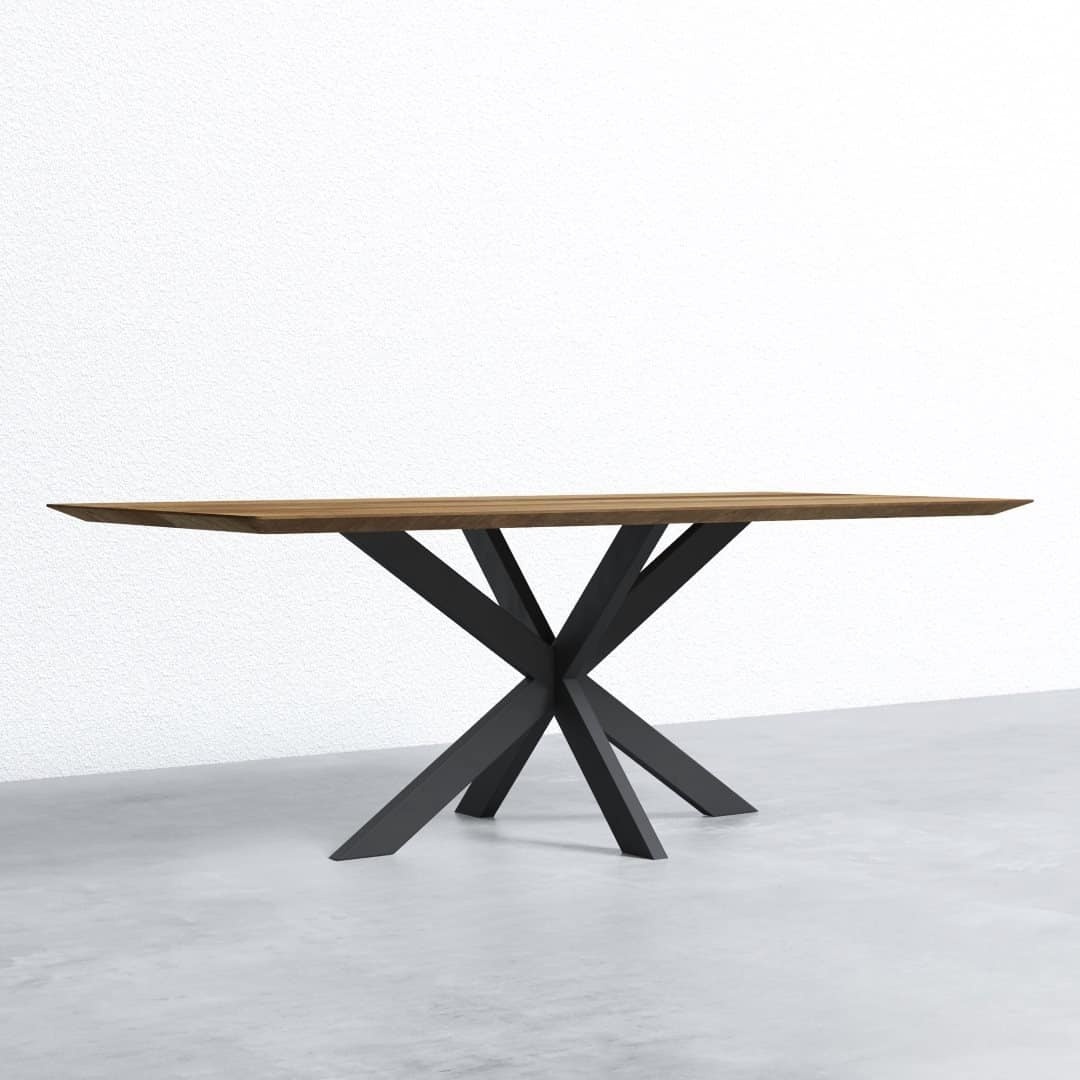 ADDITIONAL (2) KOLT 83_ DINING TABLE - AIR 011 2 A rectangular wooden table with a modern, black, geometrically designed metal base stands on a concrete floor against a white textured wall.