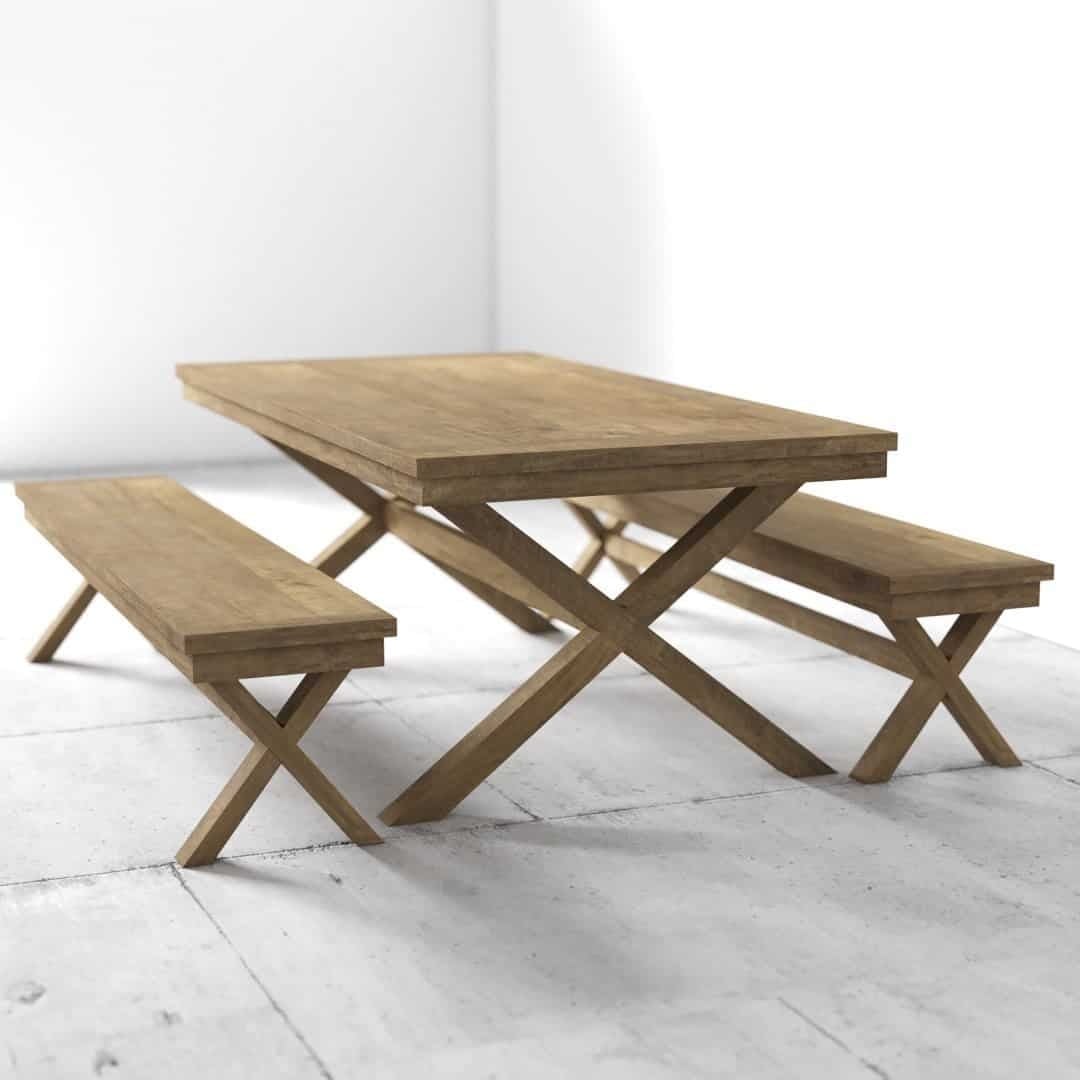 A wooden table with X-shaped legs is accompanied by two matching benches, all placed in a minimally furnished space with light-colored flooring.
