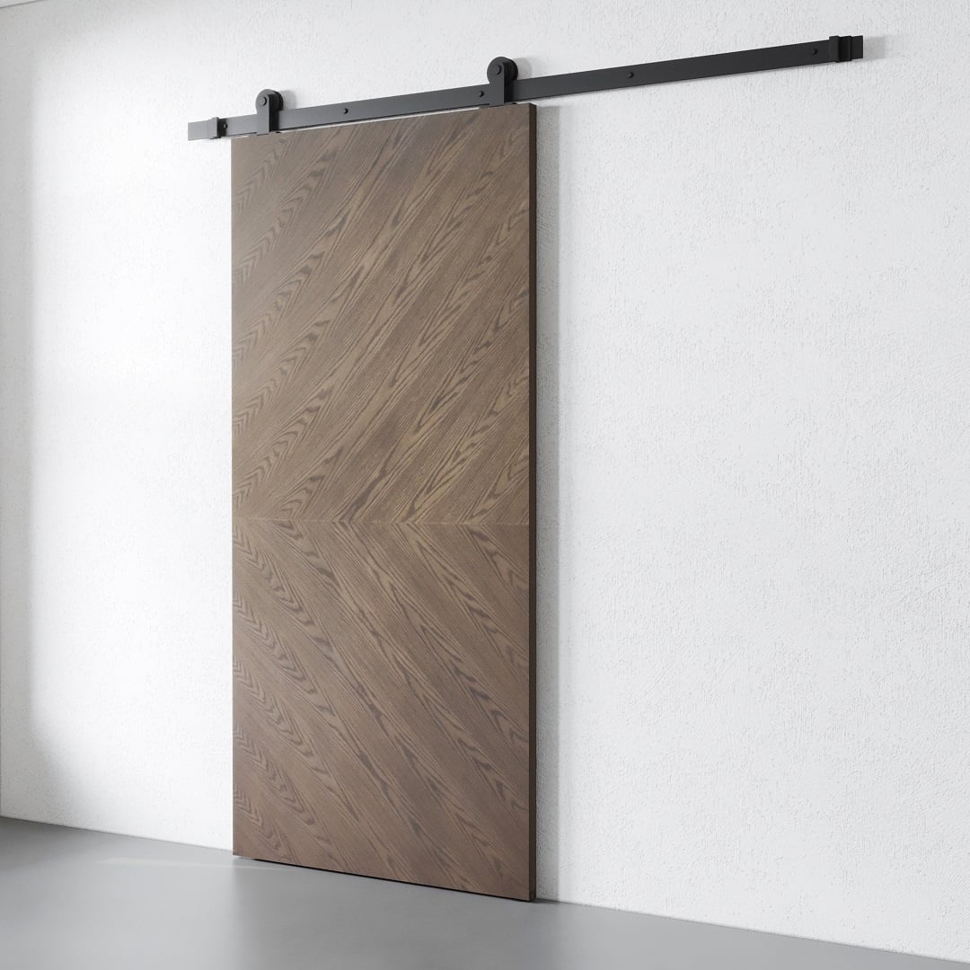 BIANCO BARN DOOR – DARK – 1 The Bianco Barn Door features a charming chevron pattern wood grain on a sleek metal rail system, perfectly complementing a white wall.