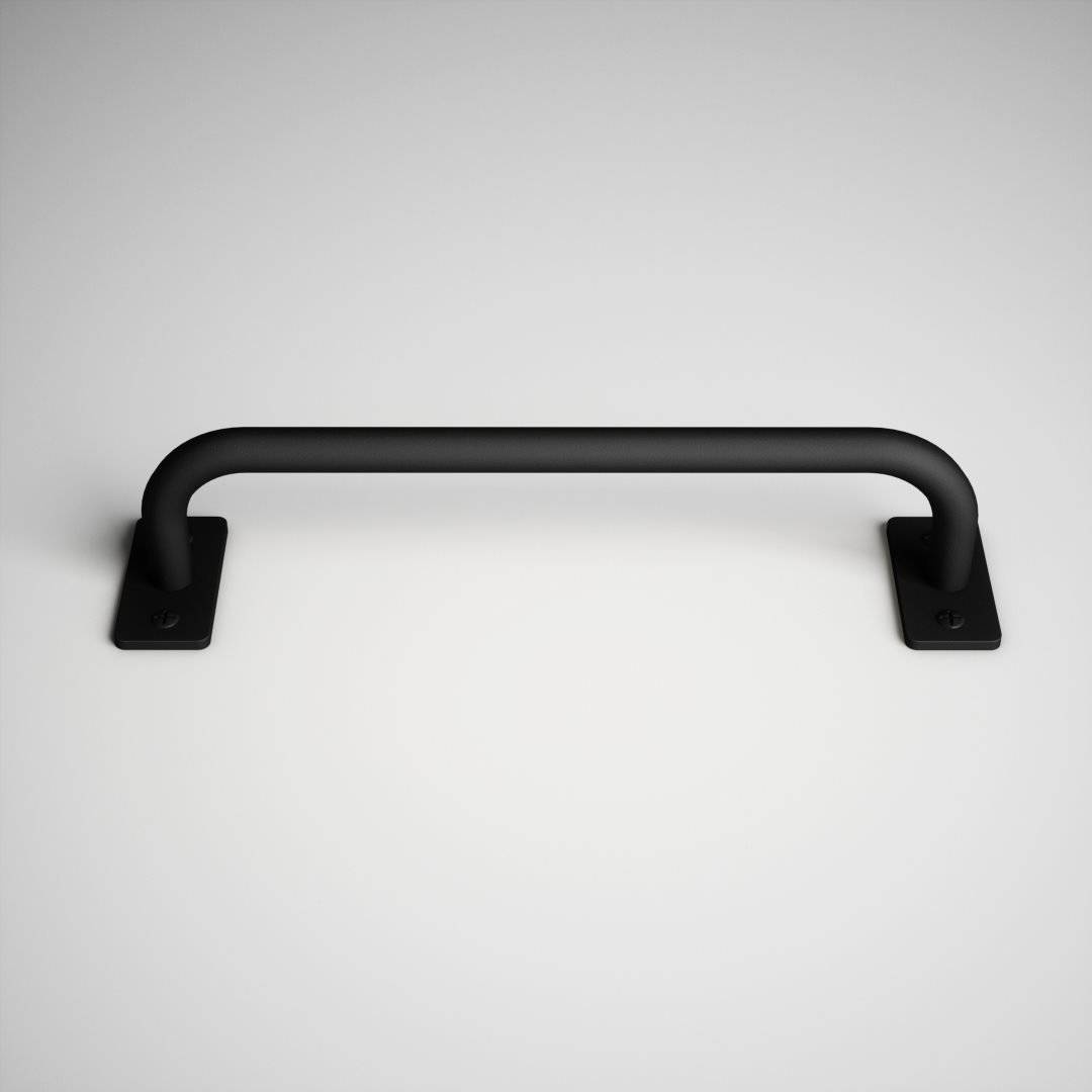 A 15th Street Barn Door Handle in black metal mounted on a white surface.