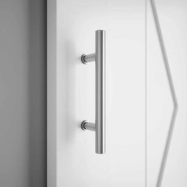 Close-up of the 17th Street Barn Door Handle, mounted on a white door. The modern silver design adds a touch of contemporary elegance to any space, reminiscent of the stylish finishes found on 17th Street.