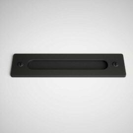 A black barn door handle with a rectangular shape and two screws on either end, mounted on a flat, light-colored surface.