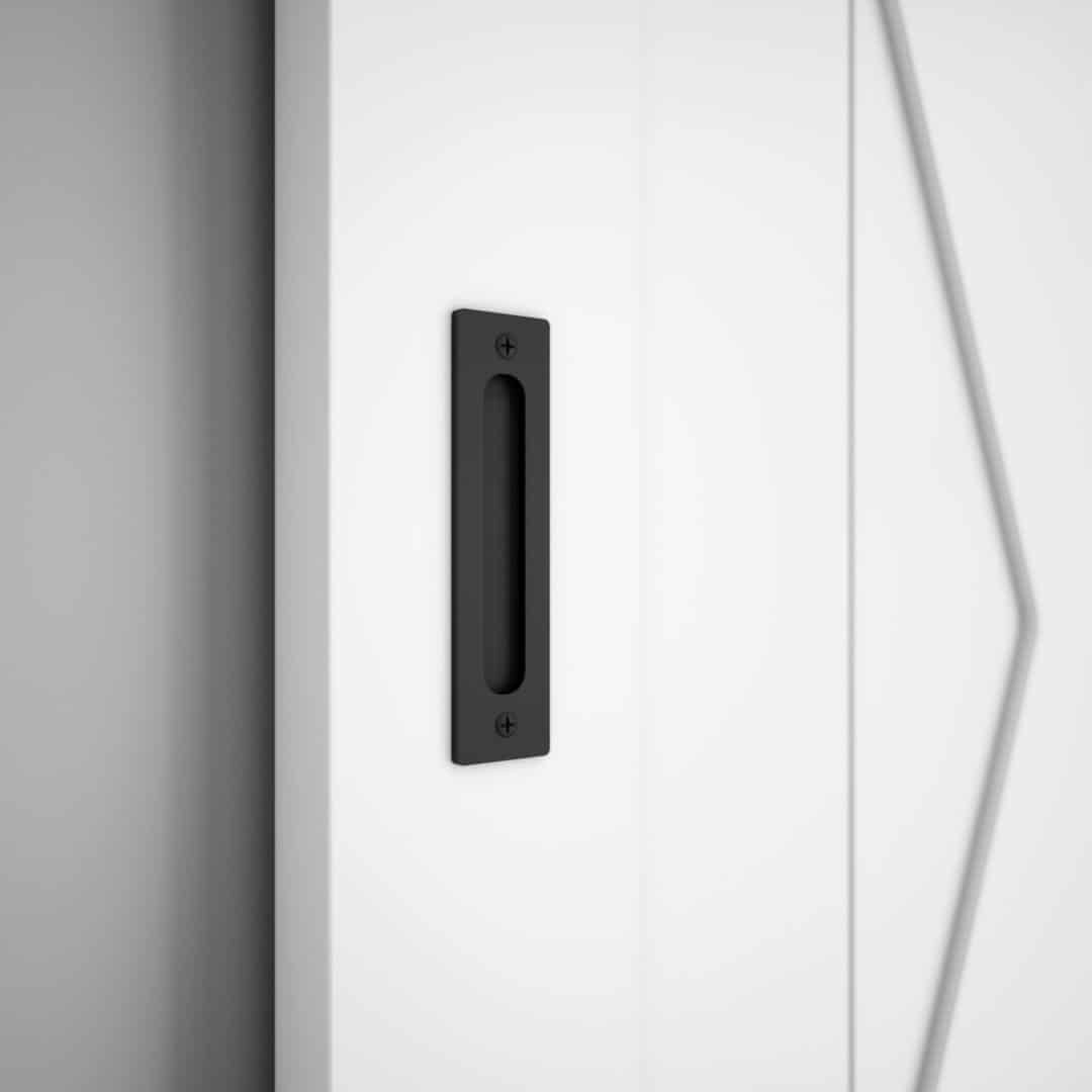 19 th street black door Close-up of a 20th Street Barn Door Handle on a white sliding door with geometric design accents.