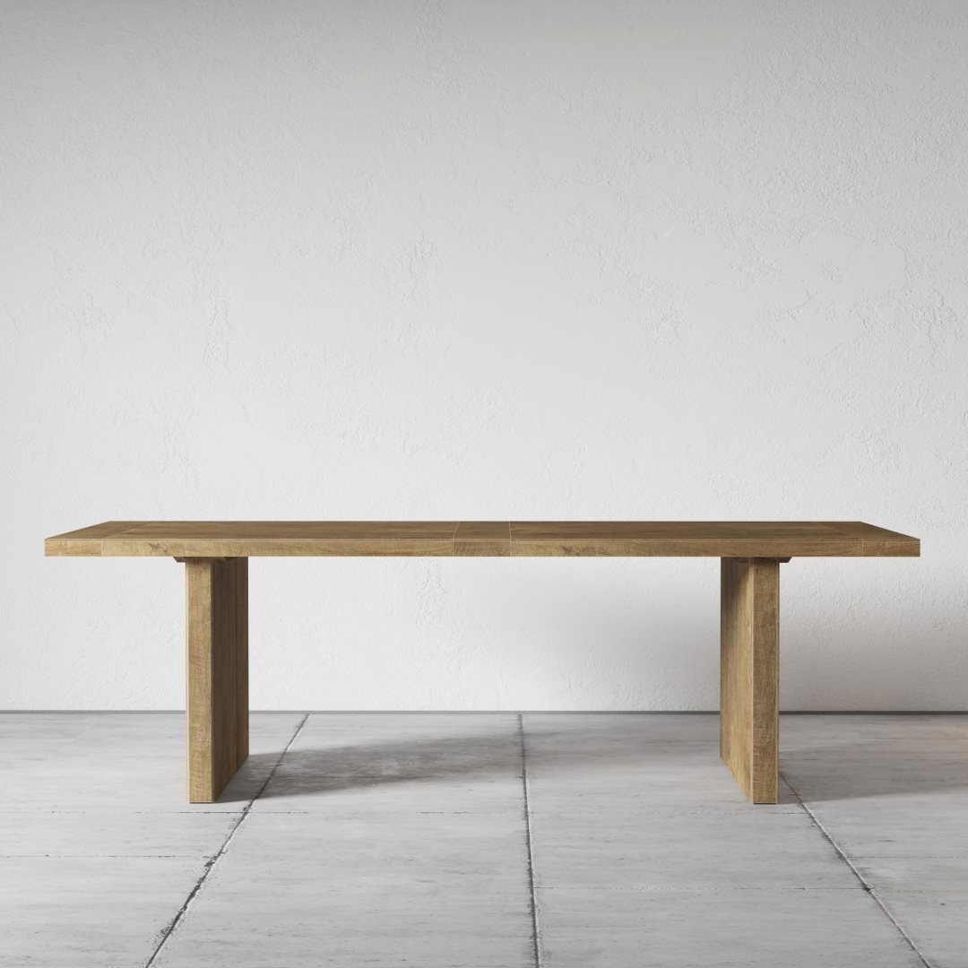The Camden Dining Table, with its simple yet elegant rectangular design, sits gracefully on a tiled floor against a plain, white wall.