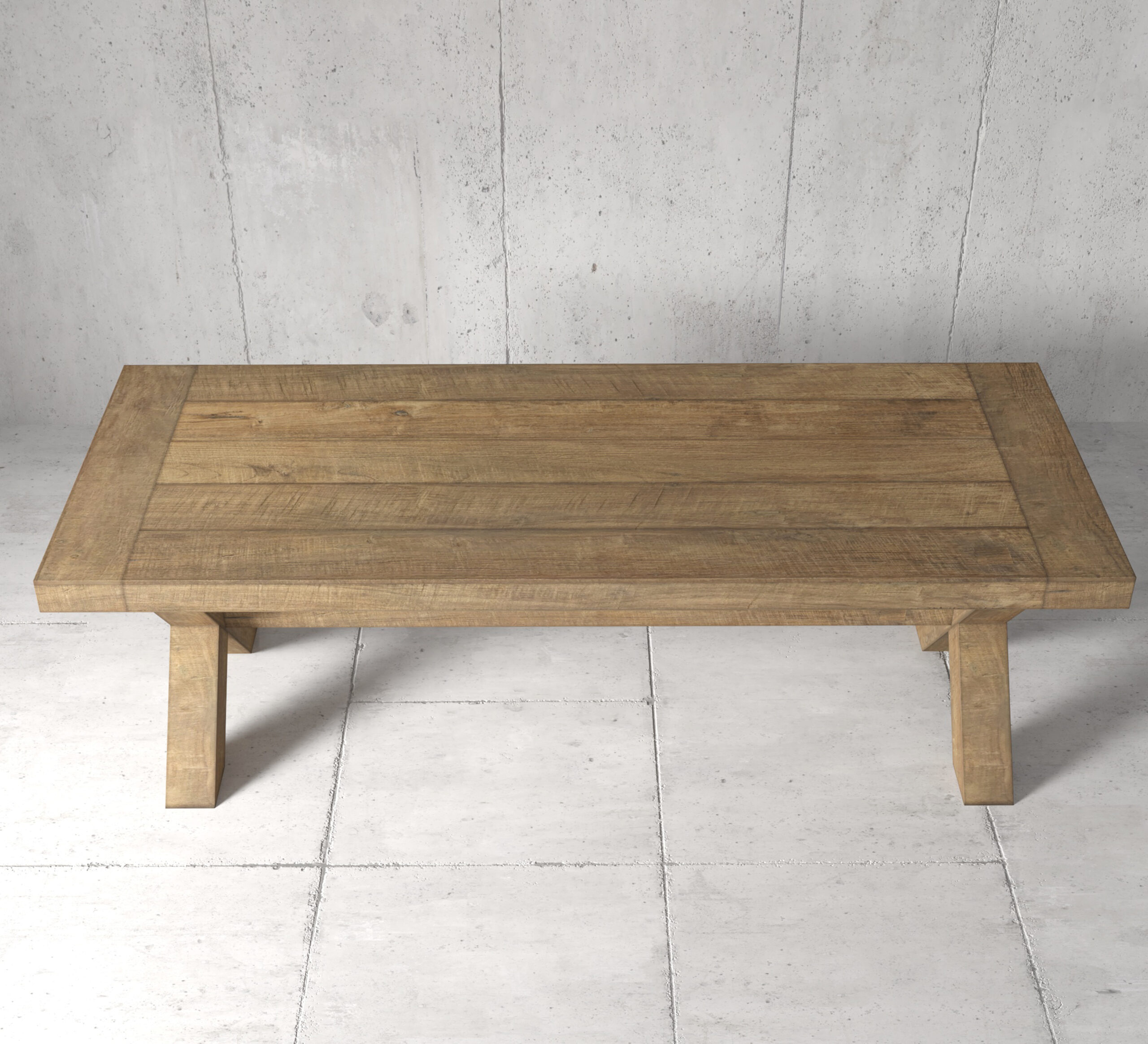 GRAND CROSS 3 The Grand Cross Dining Table, a wooden rectangular piece with thick legs, stands on a tiled floor against a concrete wall background.