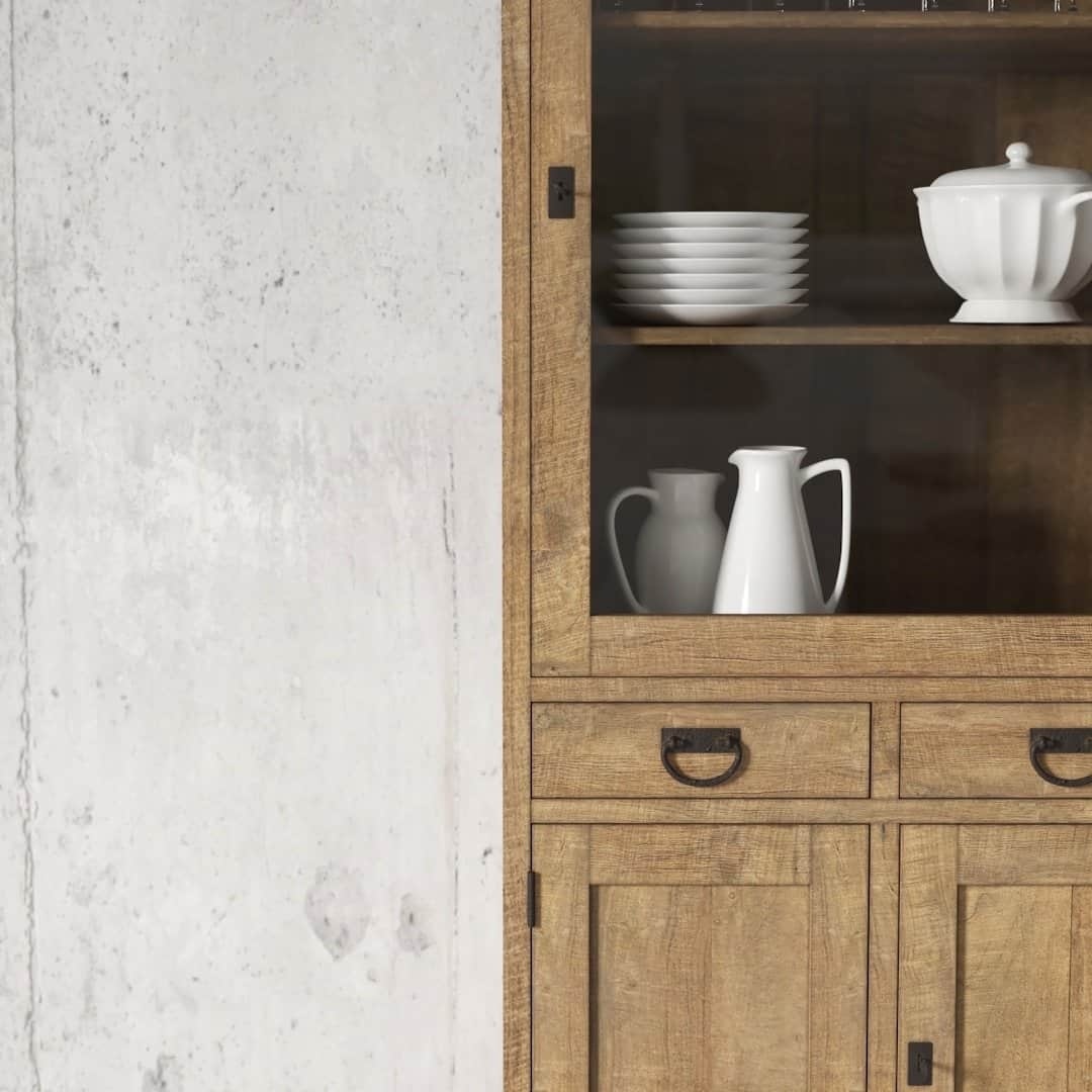 Urban Woodcraft 36 Riverbend Display Consol - Natural (3) The Riverbend 36" Display Cabinet is positioned against a concrete wall, showcasing white ceramic dishware, including plates, a teapot, and a pitcher.