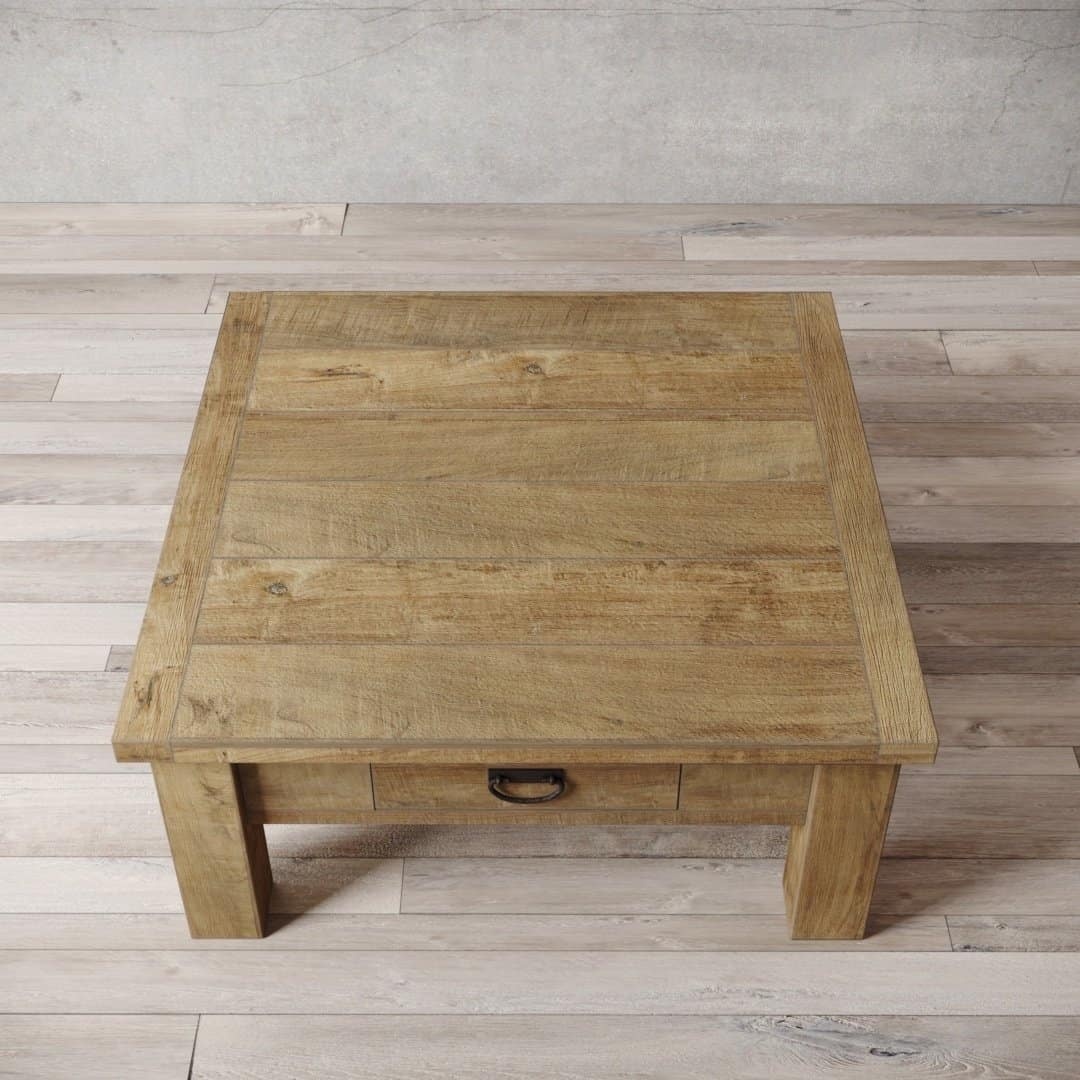 Urban Woodcraft 40 Riverbend Coffee Table - Natural (2) A top-down view of the Riverbend Coffee Table, a rectangular wooden coffee table featuring a single drawer, positioned on a light wooden floor against a gray wall.