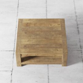 A Villa Coffee Table with a shelf sits on a light-colored tiled floor.
