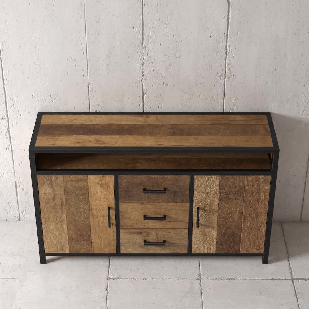 Urban Woodcraft 60 Opus Dining Buffet - MultiColoured Teak (3) The Opus Dining Buffet, characterized by its wooden construction and black metal frame, with two side doors and three central drawers, positioned against a textured concrete wall.