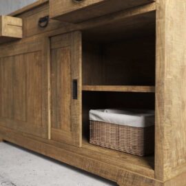 The Riverbend Sliding Door Dining Buffet features a wooden cabinet design with an open shelf that includes a wicker basket, along with a drawer and a closed compartment situated above the shelf.