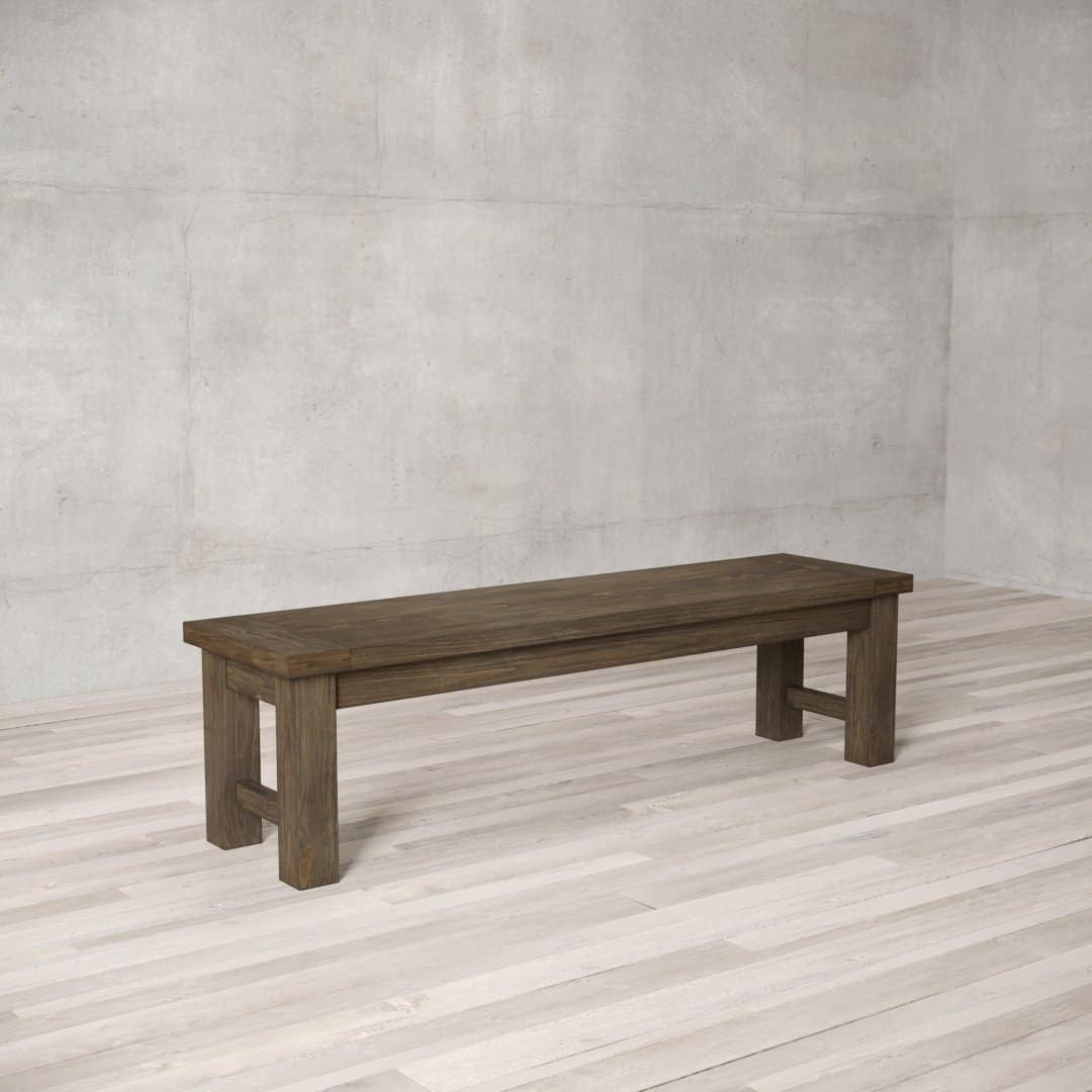 A Square Dining Bench, featuring a simple, sturdy design, is placed on a light-colored wooden floor in an empty room with gray textured walls.