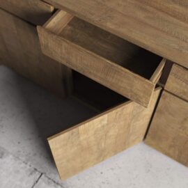 The Teca Dining Buffet, with an open drawer and an open lower door, is placed on a concrete floor.
