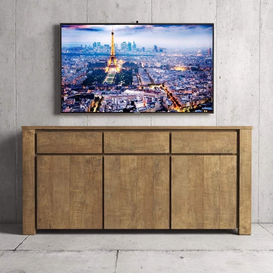 Urban Woodcraft 75 Teca Dining Buffet - Natural TV A Teca Dining Buffet stands against a concrete wall under a mounted TV displaying a cityscape with the Eiffel Tower.