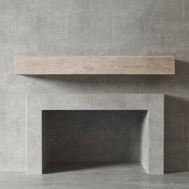 A minimalist concrete textured wall in Duluth features a floating wooden mantel above an empty modern concrete fireplace.