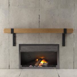 The Hudson Wall Mantel features a minimalist fireplace set against a modern concrete wall background, complete with a sleek wooden mantel. Inside the black-framed fireplace, a small fire burns gently.