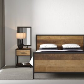 A bedroom interior featuring the Opus Bed with a wooden frame and headboard, complemented by two pillows, a side table with a lamp, a clock, and a minimalist mirror against a plain white wall.