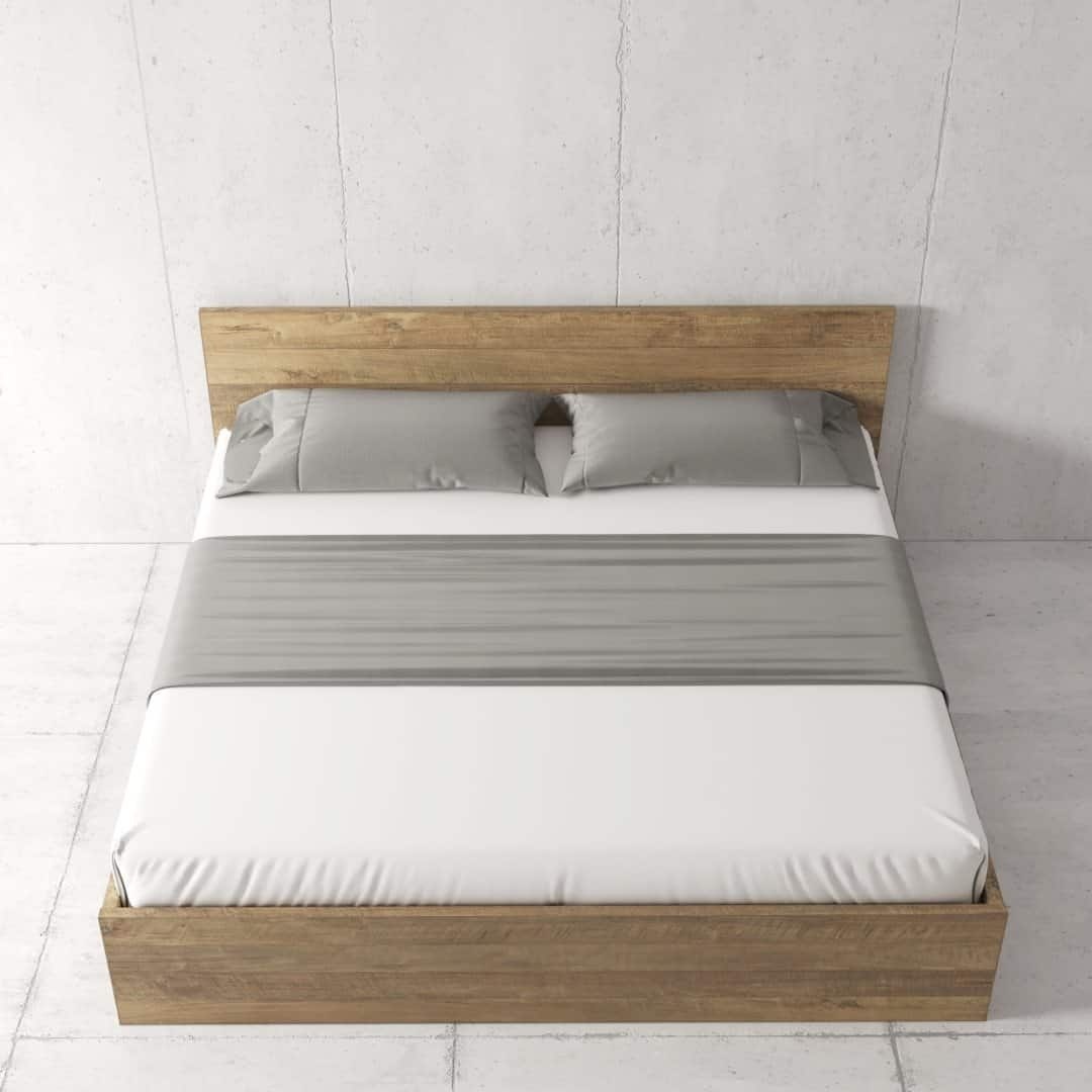 Urban Woodcraft Staillo Bed - Natural (2) The Satillo Bed features a minimalist wooden frame complemented by a white mattress, gray pillows, and a matching gray bed runner, all set against a plain light-colored wall.