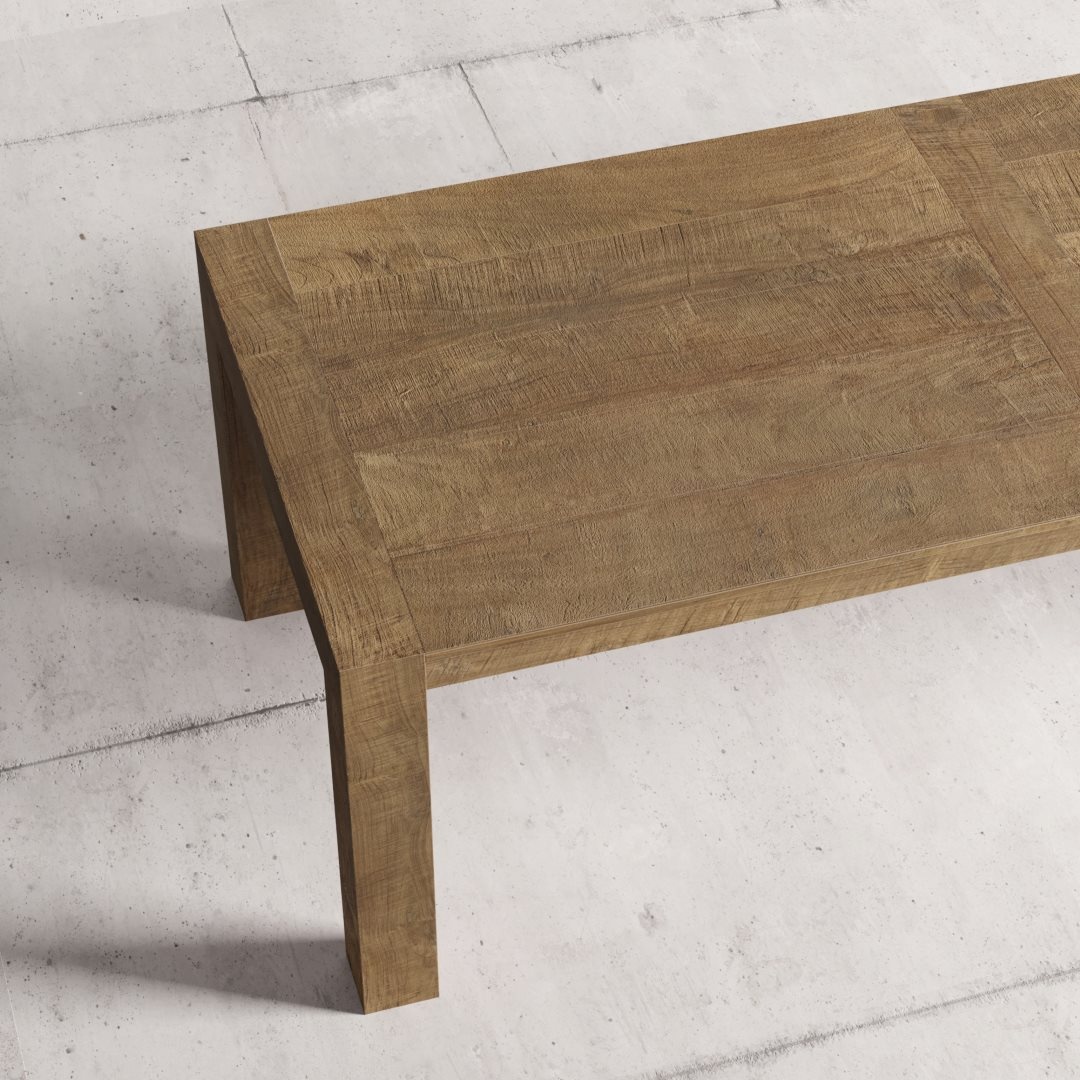 Villa 98 natural 4 A close-up view of the Villa Dining Table in its natural finish, set against a light concrete background.