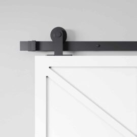 Close-up view of the Canal Barn Door, featuring a white finish and a black metal rail, mounted on a gray wall.