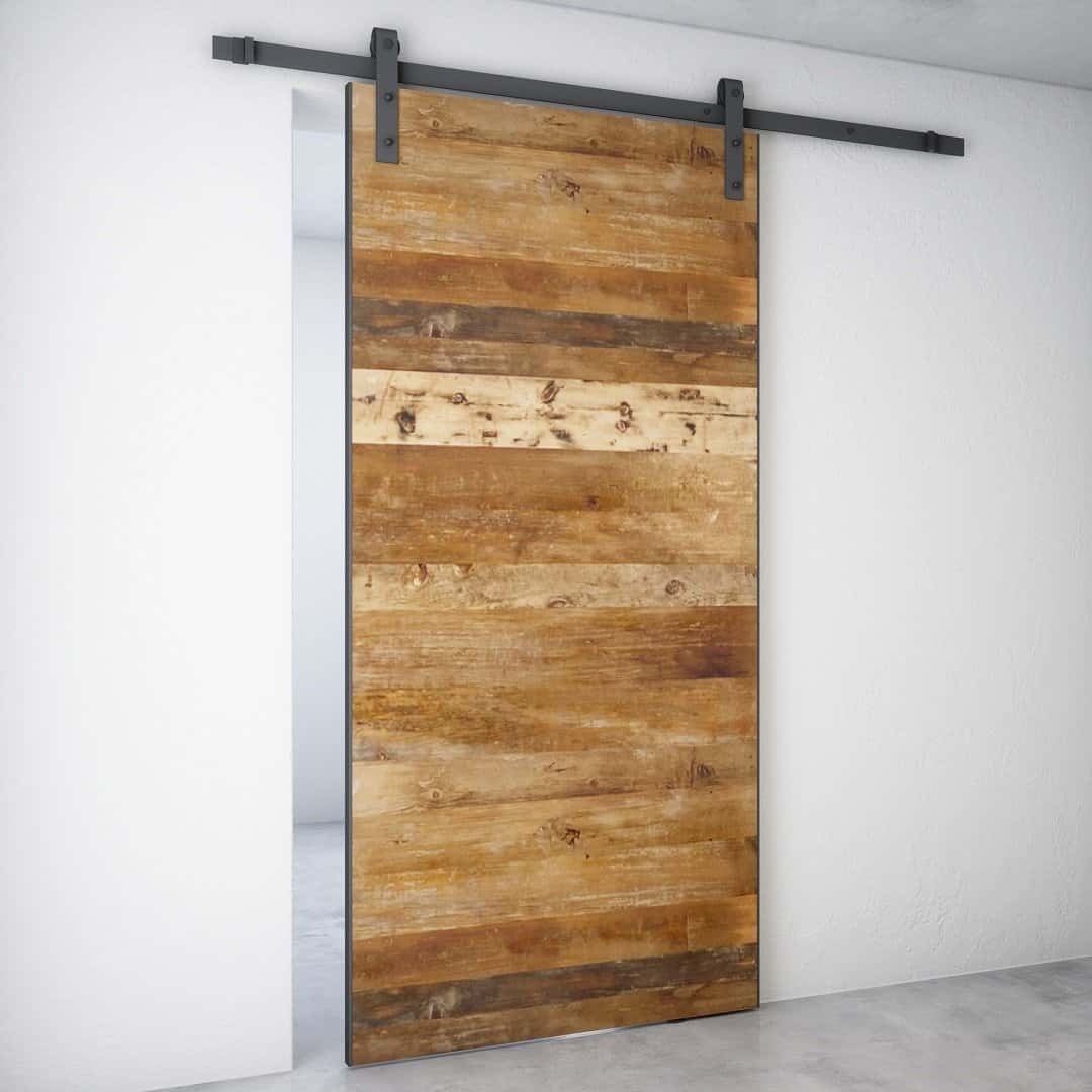 A Maison 83" x 40" barn door with a metal track installed on a white wall.