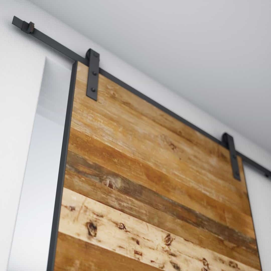 maison reclaimed doof A close-up of the Maison 83" x 40" Barn Door on a metal sliding track system installed on a white wall.