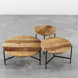 A 3-Piece Round Coffee Table with Star Legs arranged on a grey concrete floor.