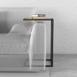 A modern Side Table featuring a black metal frame and a wooden top, placed next to a white sofa. The table holds two books and a pair of glasses.