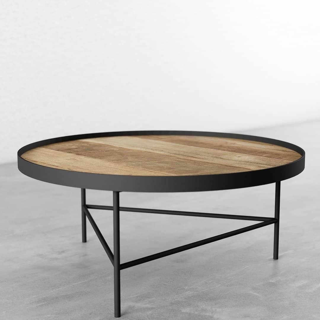 KL015 3 A Round Coffee Table featuring a wooden top and black metal frame, placed on a gray floor and positioned against a white wall.