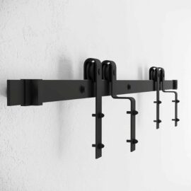 A Single Track By-Pass black metal sliding barn door hardware kit mounted on a white wall.