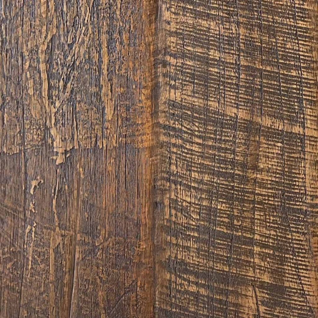 A close-up view of a weathered, textured wooden surface with visible grain and patterns.