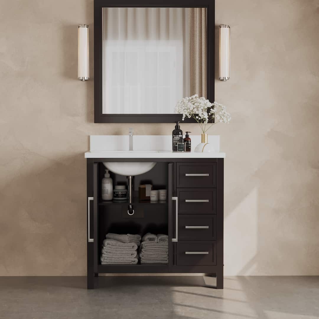 The Acadian 36" Single Sink Bathroom Vanity features a sink, faucet, and a dark wood cabinet. The cabinet includes a combination of drawers and an open shelf with neatly folded towels. Positioned above it are a large mirror and two wall lights.