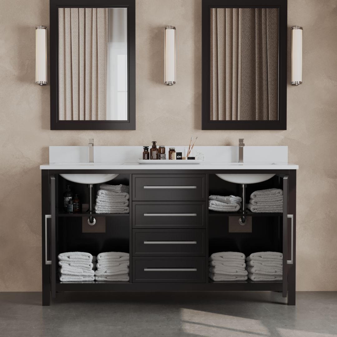 An elegant double sink bathroom vanity with espresso-hued Acadian cabinets, neatly folded towels, and various toiletries. The vanity is accentuated by two mirrors and sconces above it.