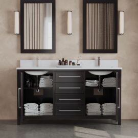 An elegant double sink bathroom vanity with espresso-hued Acadian cabinets, neatly folded towels, and various toiletries. The vanity is accentuated by two mirrors and sconces above it.