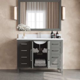 The Acadian 48" Single Bathroom Vanity with double doors open, revealing neatly stacked white towels. The countertop features a vase with white flowers, soap dispensers, and is complemented by a large mirror with wall lights on each side.