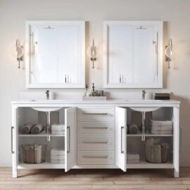 The Acadian 72" Double Sink Bathroom Vanity, featuring a white finish, comes with two mirrors, open cabinets displaying towels and baskets, and wall-mounted light fixtures on either side.