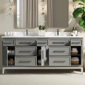 The Barrington Double Sink bathroom vanity features grey drawers and cabinets, mirrored walls, and decorative lighting. Towels, baskets, and toiletries are neatly organized inside and on the countertop, making this espresso-finished piece both functional and stylish.