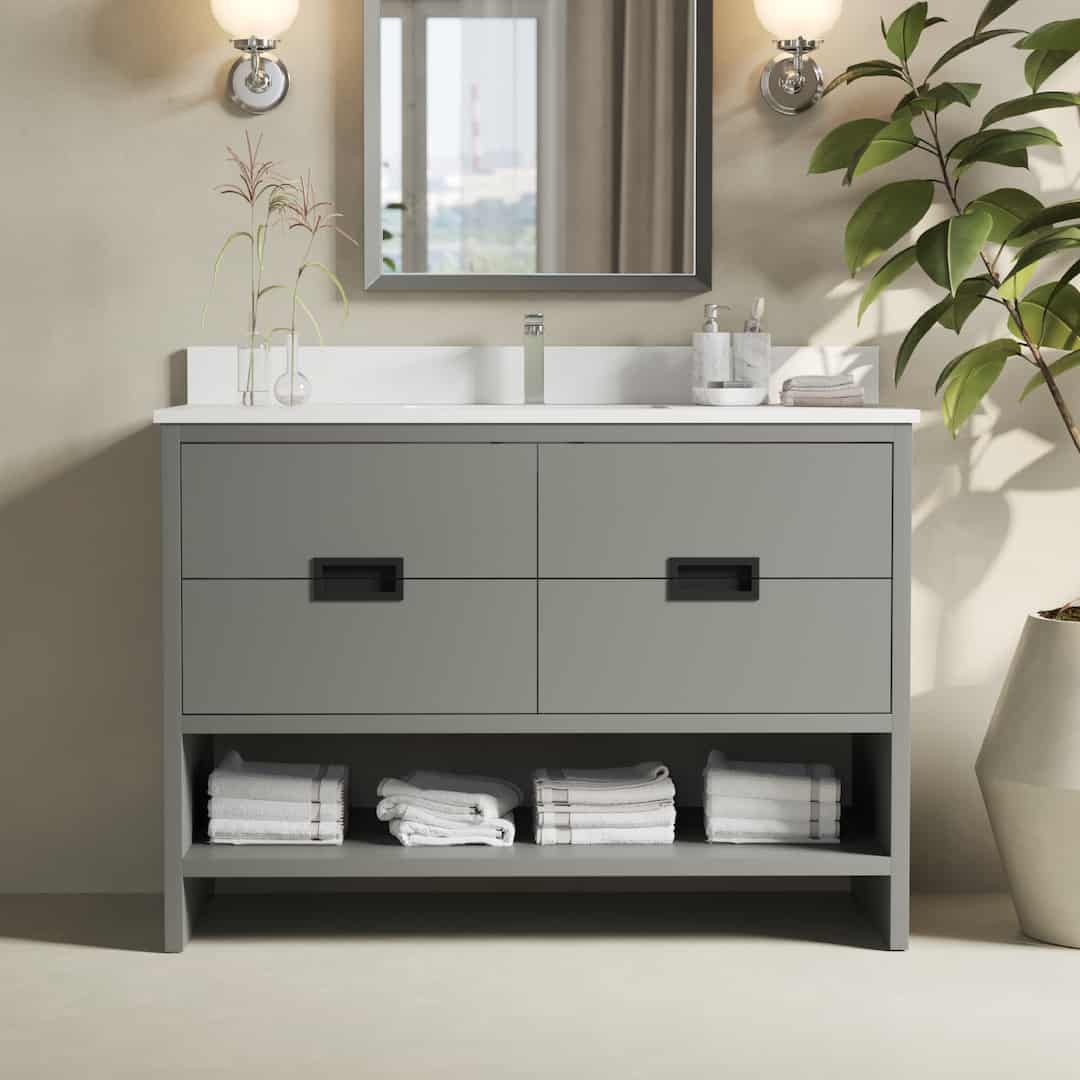 The Delamere 48" Single Sink Bathroom Vanity features a rectangular mirror, two light fixtures, a plant, and neatly folded white towels on its lower shelf.