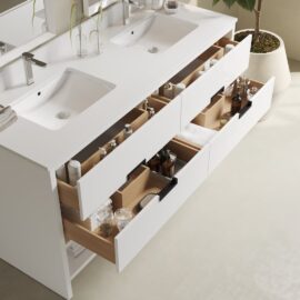 The Delamere 63" Single Sink Bathroom Vanity features open drawers that are neatly organized with various toiletries, bottles, and containers. A large potted plant is placed nearby for a touch of greenery.