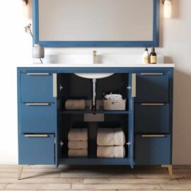 The Mendocino 48" Single Sink Bathroom Vanity in blue features open cabinets that neatly display folded towels and storage baskets below a pristine white countertop and sink, adorned with bottles and a vase on the counter.