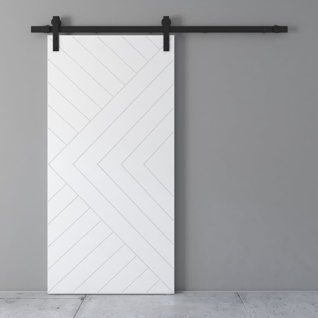 A Lucas 83" x 40" Reclaimed Wood Arrow Barn Door, featuring a chevron pattern and mounted on a black sliding rail system, set against a grey wall and a concrete floor.