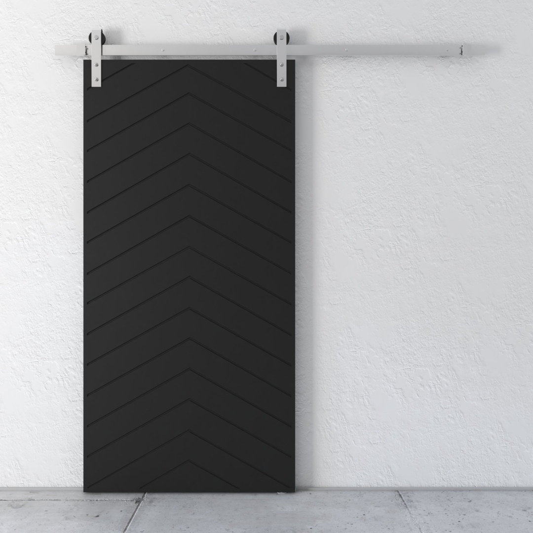 A Lucas 83" x 40" Reclaimed Wood Arrow Barn Door in black, featuring a chevron pattern, mounted on a white wall using a silver track system.