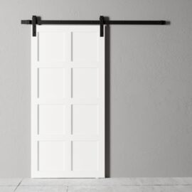A Lucas 83" x 40" Reclaimed Wood Arrow Barn Door with a black metal track is mounted on a gray wall.