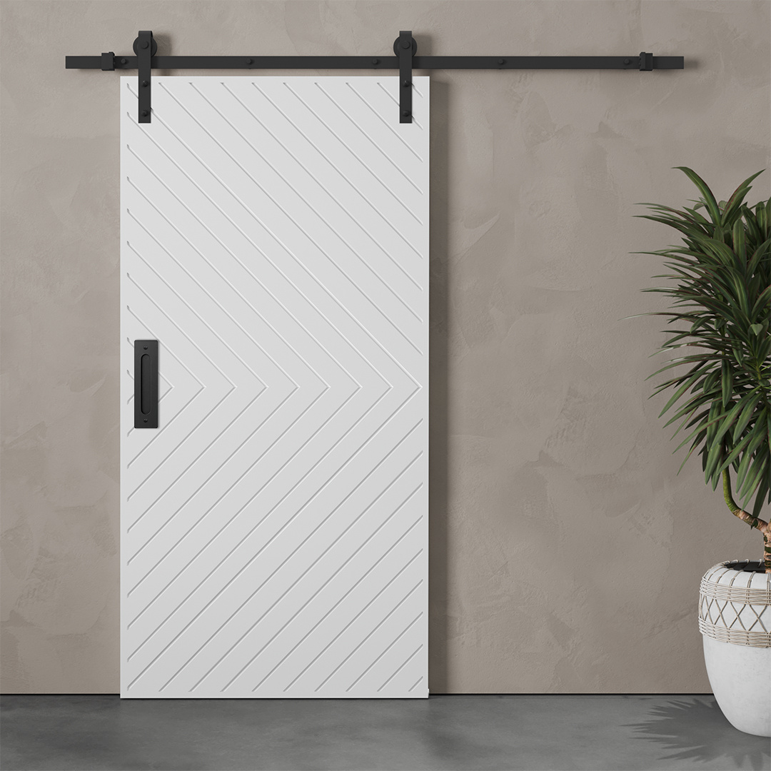 The Venice 83" x 40" Arrow Barn Door, featuring a chevron pattern, is mounted on a black track against a gray textured wall. A potted plant is placed on the right side.
