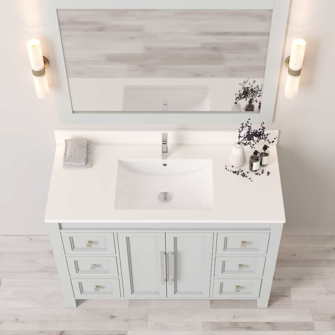 48_ Single Sink Belluno Vanity (Grey) - 5 The Belluno 48" Single Sink Vanity in white features a large mirror and two wall-mounted lights. The vanity includes multiple drawers and a white countertop with an integrated sink, adorned with a towel and decorative items on the surface.