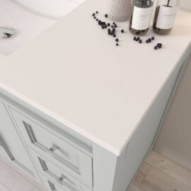 A Belluno 48" Single Sink Vanity featuring a white countertop with a few dark berries scattered and two bottles, one labeled "HAND WASH," alongside a vase. The vanity also includes drawers underneath the countertop.