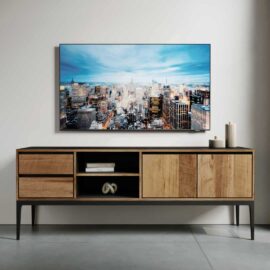 Modern living room with the Kolt 60" 2 Shelf TV Stand, featuring closed cabinets and open shelves, below a mounted flat-screen TV displaying a cityscape. Simple decor items placed on the stand.