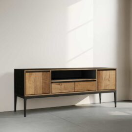 The Kolt 60" Wide TV Stand, featuring a modern wooden design with black accents, two cabinets, two drawers, and an open shelf, is set against a light-colored wall with a shadow falling across it.