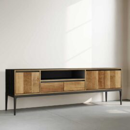 The Kolt 60" Wide TV Stand, with its minimalist design featuring wooden doors and a black frame, includes two central drawers and an open shelf, perfectly set against a plain wall in a well-lit room.