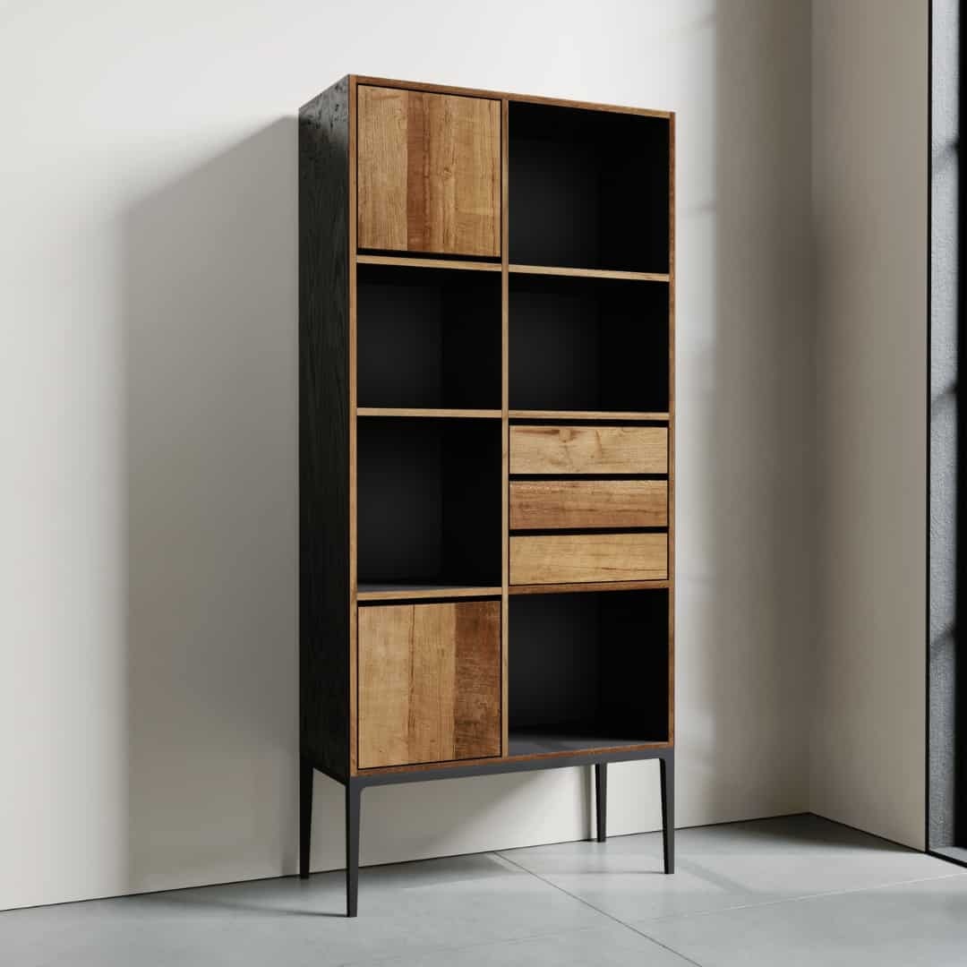 The Kolt Tall Display, a tall wooden shelving unit with a black frame, featuring multiple open compartments and closed drawers, stands in a well-lit room against a white wall.