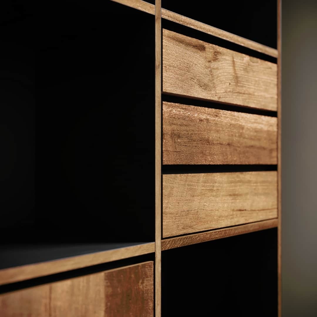 KOLT TALL DISPLAY - 3 Close-up view of the Kolt Tall Display, featuring horizontal and vertical partitions, along with two closed drawers showcasing a natural wood grain finish.